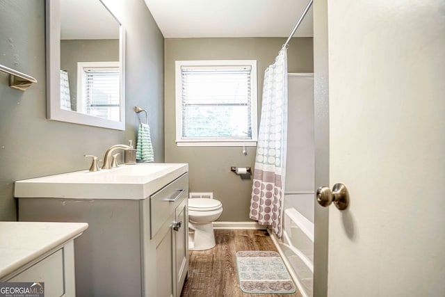 full bathroom with toilet, shower / bath combo, vanity, and wood-type flooring