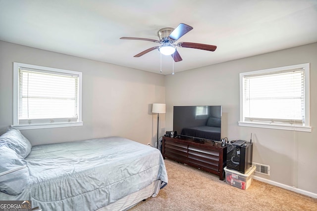 bedroom featuring light colored carpet and ceiling fan