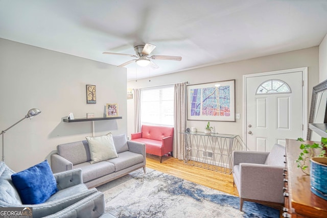 living room featuring hardwood / wood-style floors and ceiling fan