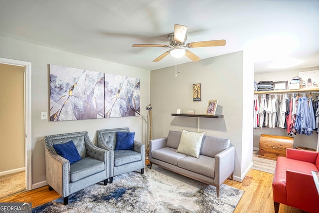 living room with hardwood / wood-style floors and ceiling fan