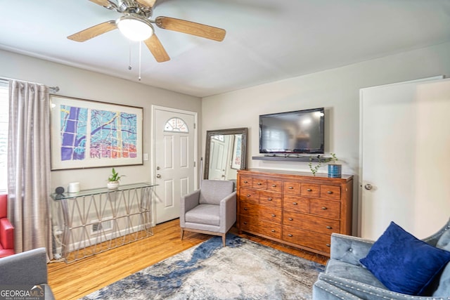 living area featuring ceiling fan and wood-type flooring