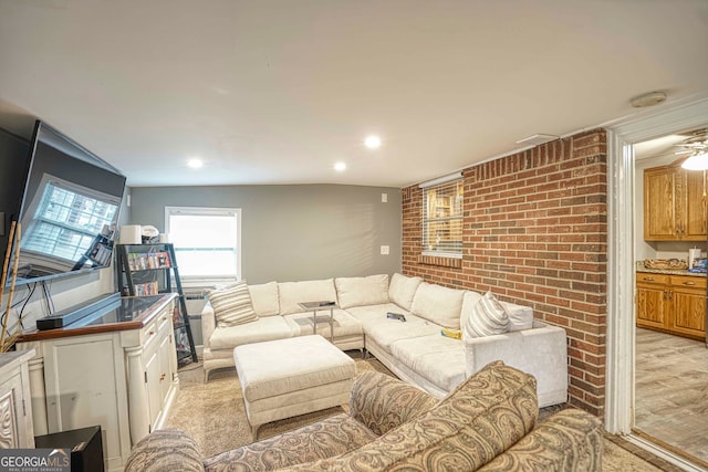 living room with vaulted ceiling, light colored carpet, and ceiling fan