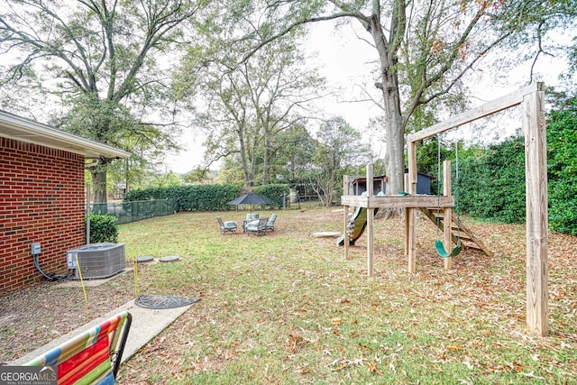 view of yard featuring a playground and central AC unit