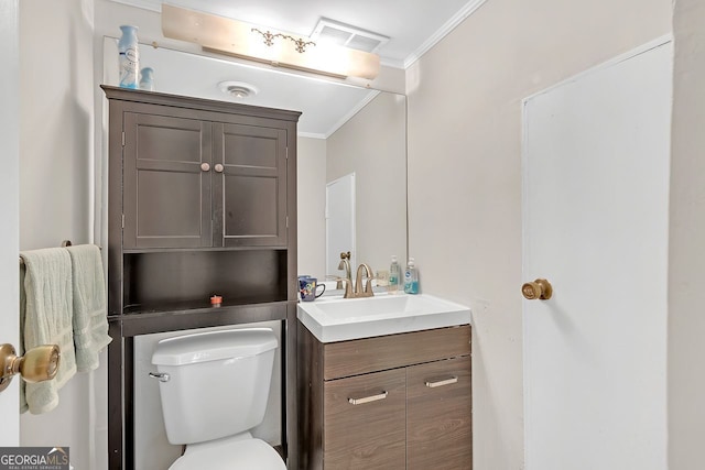 bathroom featuring toilet, vanity, and ornamental molding