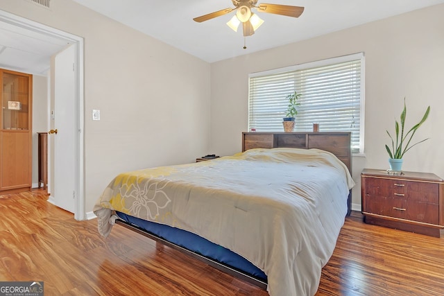 bedroom with ceiling fan and hardwood / wood-style floors