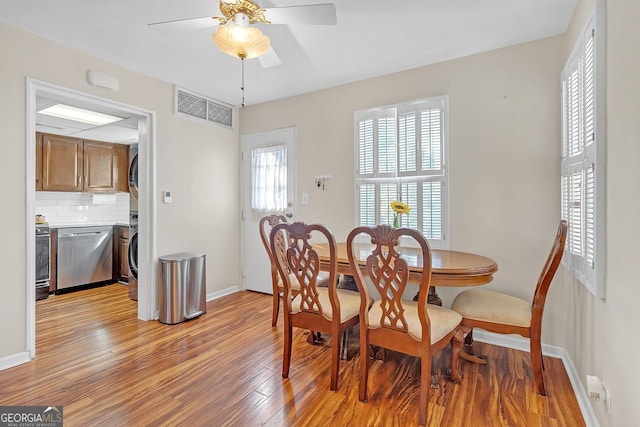 dining space with ceiling fan and light wood-type flooring