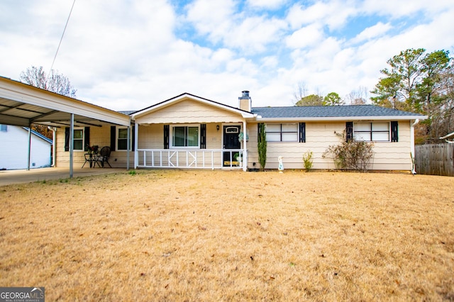 ranch-style home featuring a front lawn, a porch, and a carport