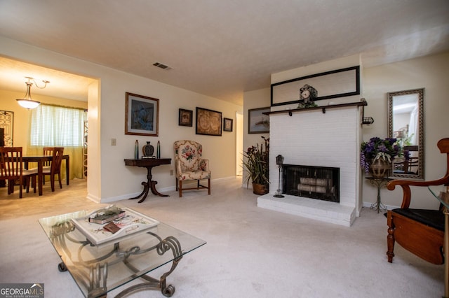 living room featuring light colored carpet and a brick fireplace