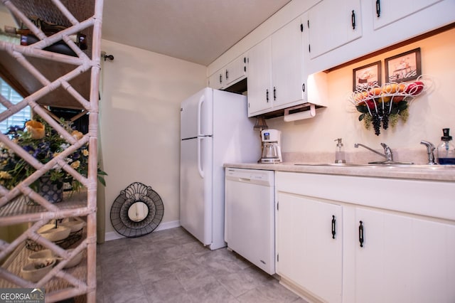 kitchen featuring white cabinetry, white appliances, and sink