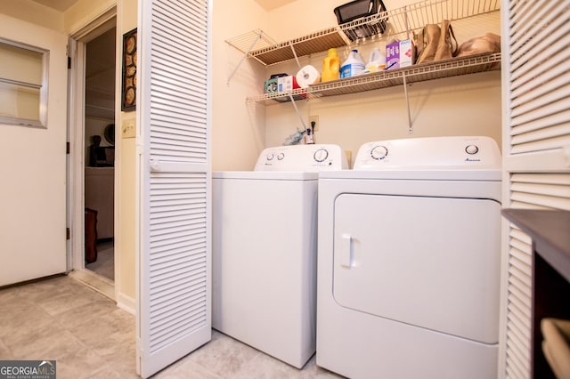 laundry room featuring washing machine and clothes dryer