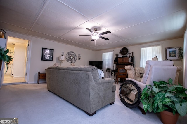 carpeted living room featuring ceiling fan