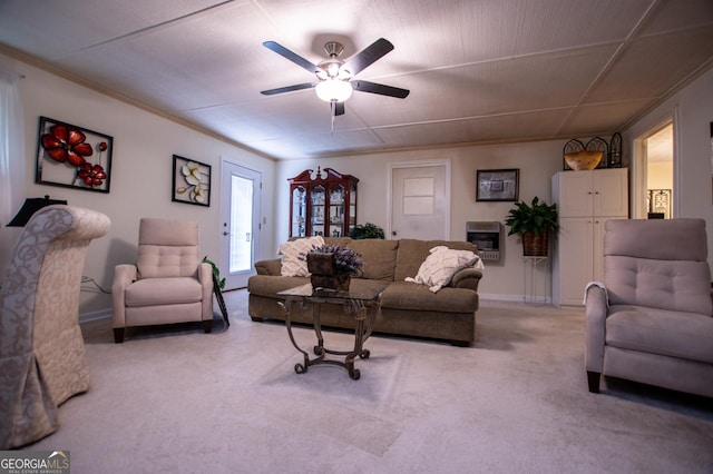 carpeted living room with heating unit, ceiling fan, and ornamental molding