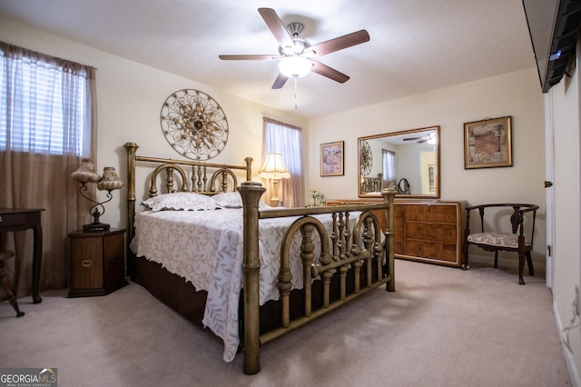 bedroom with light colored carpet and ceiling fan