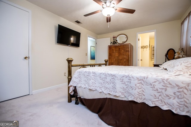 carpeted bedroom featuring ceiling fan and connected bathroom