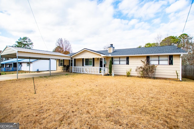 single story home featuring covered porch, a front yard, and a carport