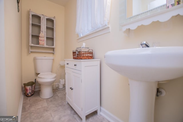 bathroom with tile patterned floors, toilet, and sink