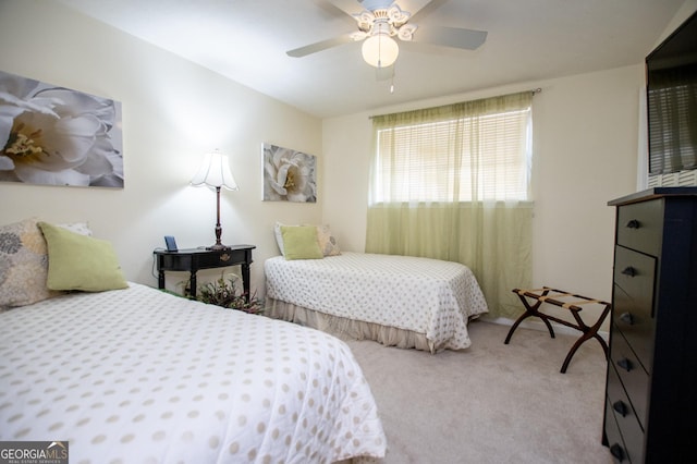 bedroom featuring light colored carpet and ceiling fan