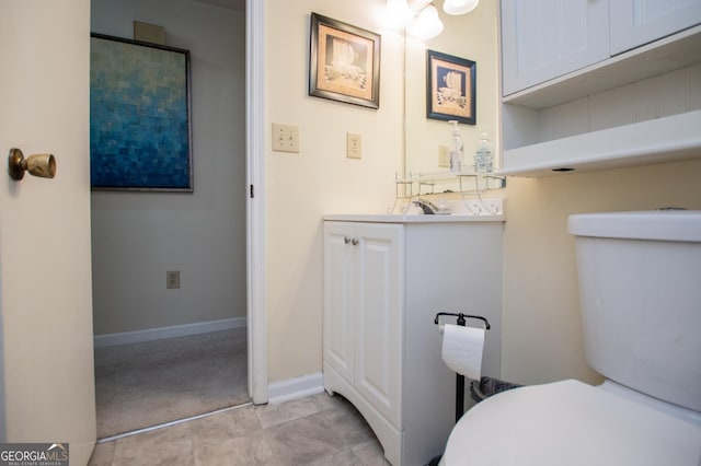 bathroom with tile patterned floors, vanity, and toilet