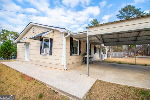 view of front of property with cooling unit and a carport