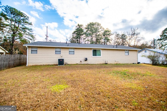 back of house featuring a lawn and central AC