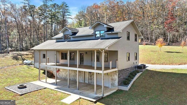 view of front of home with central air condition unit and a front lawn