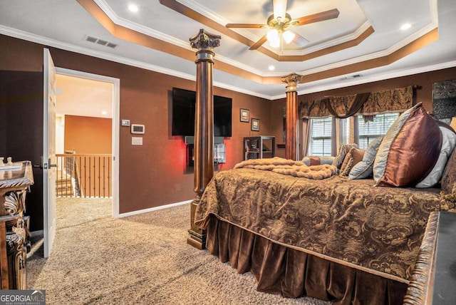 carpeted bedroom featuring ceiling fan, a tray ceiling, and ornamental molding