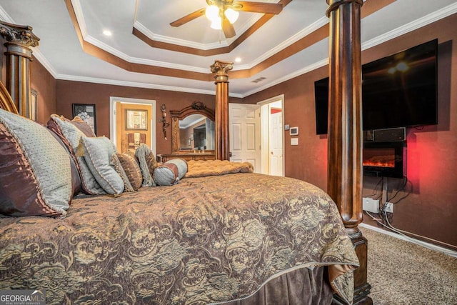 bedroom featuring carpet flooring, a raised ceiling, ceiling fan, and crown molding