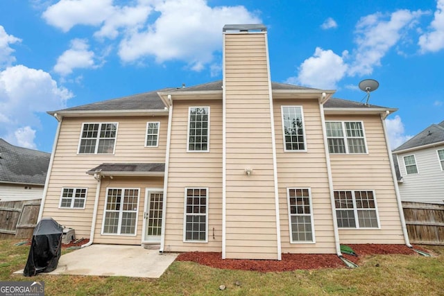 back of property featuring a patio and a yard