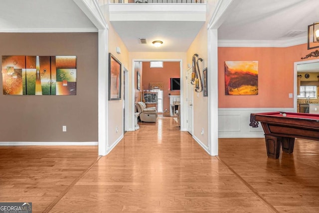 interior space featuring hardwood / wood-style floors and crown molding