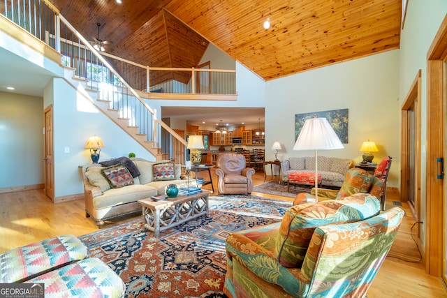 living room with ceiling fan, light hardwood / wood-style flooring, high vaulted ceiling, and wood ceiling