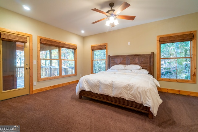 bedroom featuring multiple windows, ceiling fan, and carpet