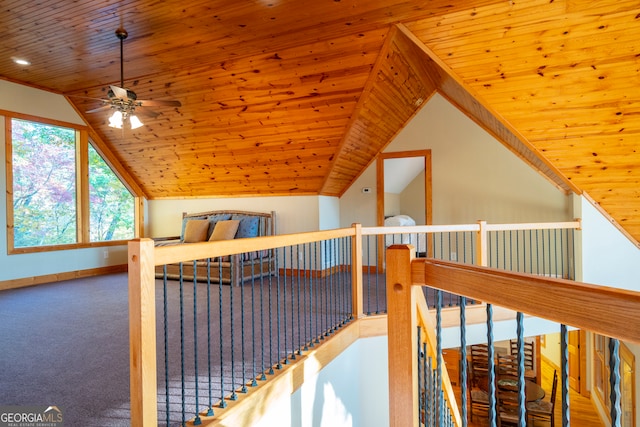 hallway with carpet floors, lofted ceiling, and wood ceiling