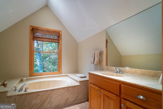 bathroom with tile patterned flooring, vanity, vaulted ceiling, and a bathing tub