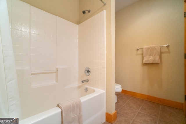 bathroom with tile patterned floors, shower / bath combination with curtain, and toilet