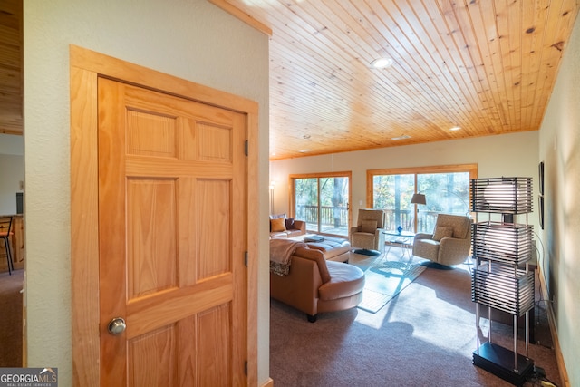 carpeted living room featuring wooden ceiling