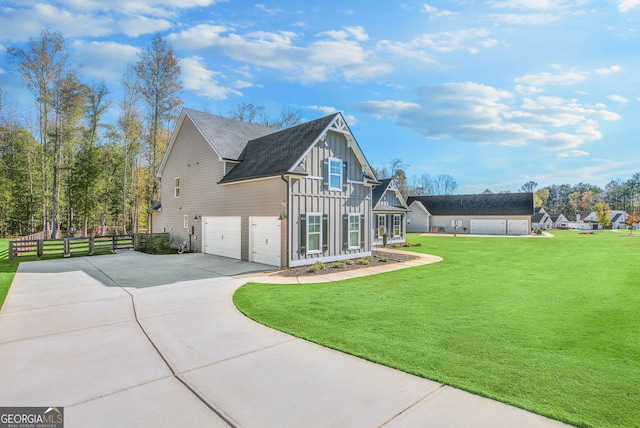 view of side of property featuring a garage and a yard