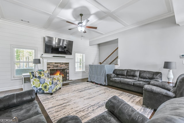 living room with wood-type flooring, a fireplace, beam ceiling, coffered ceiling, and ceiling fan