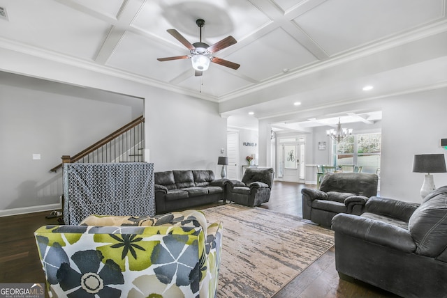 living room featuring ceiling fan with notable chandelier, dark hardwood / wood-style flooring, crown molding, and coffered ceiling