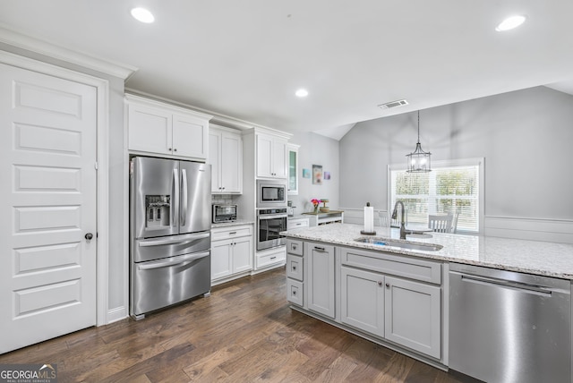 kitchen with white cabinetry, appliances with stainless steel finishes, sink, and dark hardwood / wood-style floors