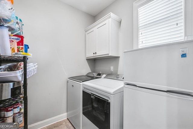 laundry room with cabinets and washing machine and dryer