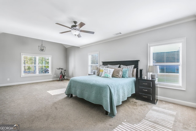 bedroom featuring light colored carpet, ceiling fan, and crown molding