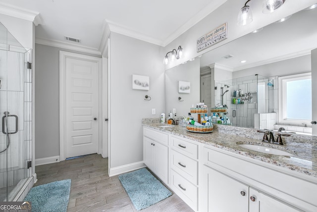 bathroom featuring hardwood / wood-style flooring, vanity, an enclosed shower, and crown molding