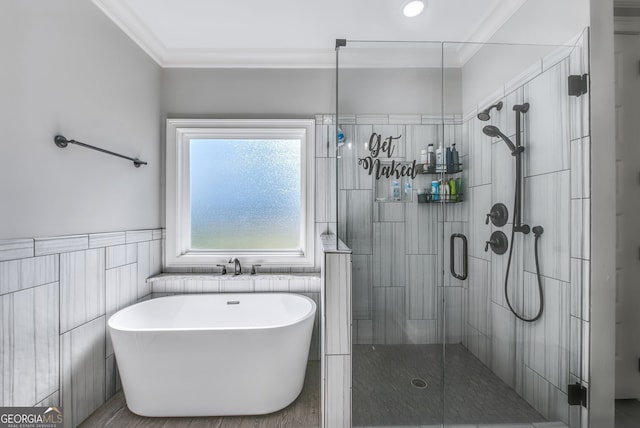 bathroom with tile walls, crown molding, and independent shower and bath