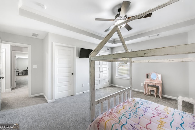 bedroom with carpet flooring, ceiling fan, and a raised ceiling