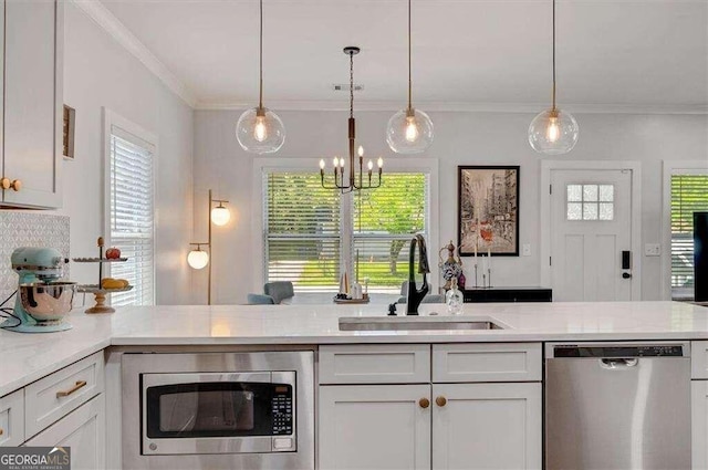 kitchen with a wealth of natural light, sink, and stainless steel appliances