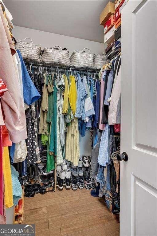 spacious closet featuring hardwood / wood-style floors