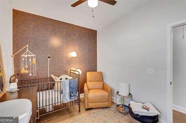 sitting room featuring hardwood / wood-style flooring and ceiling fan