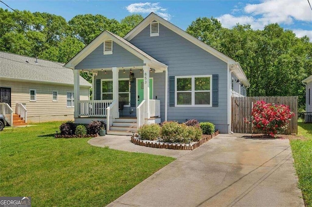 bungalow-style home featuring a porch, central AC, and a front lawn