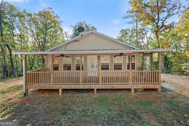 rear view of property with ceiling fan