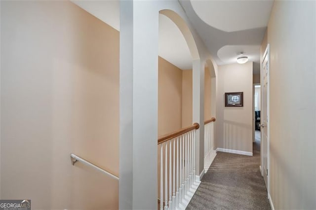 hall featuring dark colored carpet